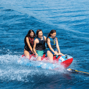 WOW Sub-Zilla 3-Person towable with three riders wearing life jackets on blue water