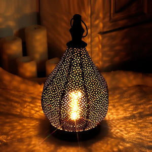 Moroccan metal table lamp, black perforated shade, cordless battery-powered with warm LED filament bulb.