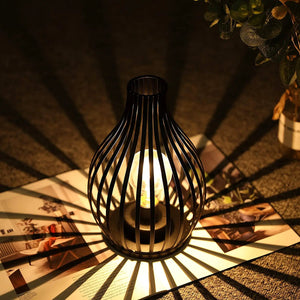 JHY DESIGN 9.5'' high battery-powered table lamp, black metal cage with warm glow bulb.
