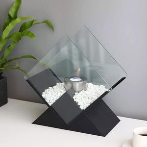 Tabletop bio-ethanol fireplace by JHY DESIGN with black geometric base, glass diamond enclosure and white stones