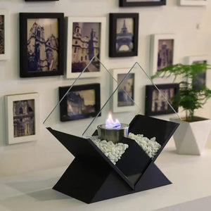 JHY DESIGN tabletop fireplace, 14.5 in tall, black base with white stones and glass panels around an ethanol burner.