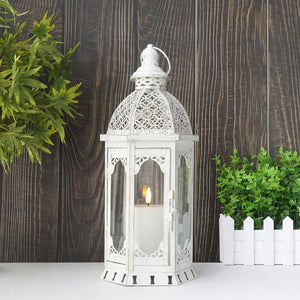 15''H white vintage metal outdoor candle lantern by JHY DESIGN with glass panels and a lit candle