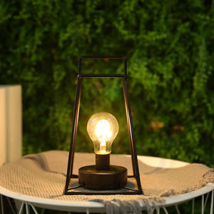JHY DESIGN 11.5in retro geometric table lamp in black metal with Edison bulb on a round outdoor table