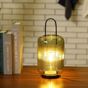 11.5''H battery-powered table lamp with amber-green ribbed glass and black metal handle