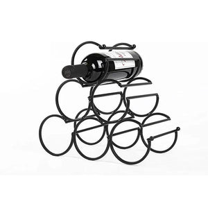Iron tabletop wine rack in black metal with circular bottle holders and a bottle resting on top.