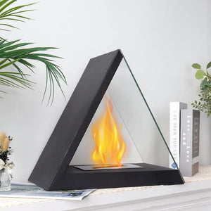 Glass tabletop fireplace by JHY DESIGN with a black triangular frame and glass sides around a visible flame