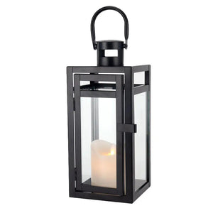 12-inch black metal decorative candle lantern with glass panels and a candle inside