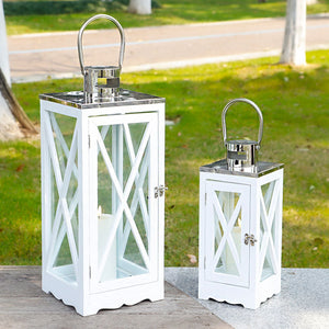 Set of 2 JHY DESIGN white metal decorative candle lanterns with glass panels and chrome tops, in tall and short sizes.