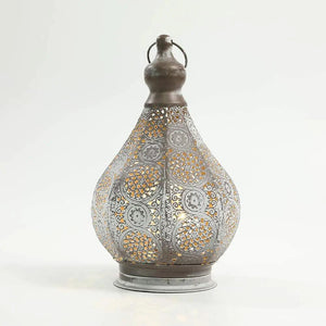 11.5'' tall battery-powered table lamp by JHY DESIGN; ornate gray perforated metal lantern emitting warm light.