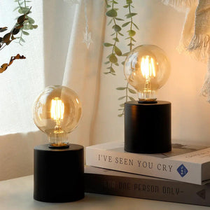 7-inch tall black battery-powered table lamps set of 2 by JHY DESIGN with clear Edison bulbs.