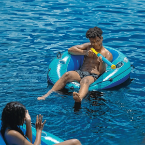 WOW Watersports Splash Cannon water toy on blue inflatable raft with a yellow water cannon.