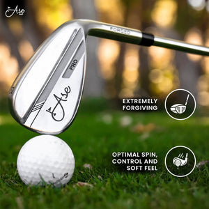 Ase 3-Piece Wedge Set forged silver wedge with Ase Golf logo, surrounded by white golf balls on grass.