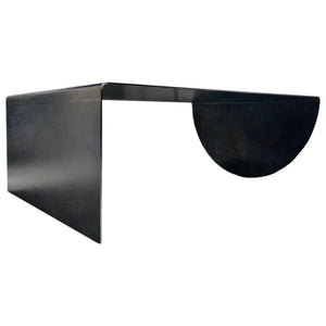 Asymmetrical heavy-duty metal coffee table in raw steel with a curved end