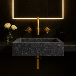 Gray marble vessel sink by BROSMARBLE with gold faucet and gold fixtures.
