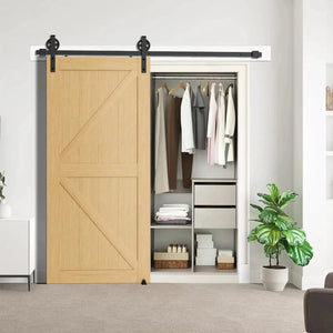 HAUSVITA Big Spoke Wheel Sliding Barn Door Hardware Kit in black with two wheel hangers mounted above a wooden sliding door