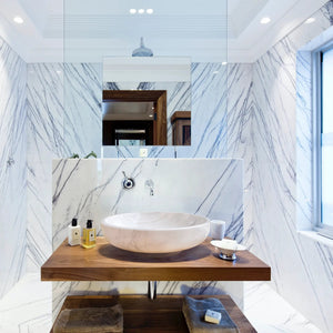 Calacatta white marble vessel bathroom sink by Villohome on a wooden vanity