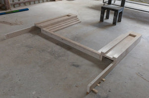 Cappuccino beige marble fireplace mantel components in a workshop, hand-carved Art Deco style.