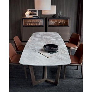 Marble dining table, rectangular with a polished and eased edge, surrounded by four brown upholstered chairs