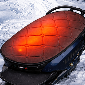 LITEGUEST heated motorcycle seat cover on a blue motorcycle; red quilted fabric with warm orange heating glow.