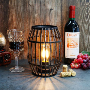 Cordless metal wine-barrel lamp, 8"H, black brushed-gold finish with warm glow, battery operated.