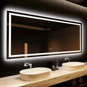 Deluxe Center Glow LED bathroom mirror with edge-lit rectangular frame above double white sinks.