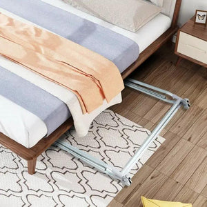 Folding extendable metal garment rack with lockable wheels, silver finish underneath a bed.