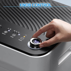 TURBRO Finnmark 10,000 BTU portable air conditioner control panel with a large chrome knob being pressed by a hand