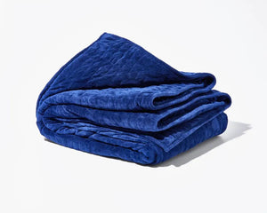 Original Weighted Blanket folded in deep blue with a quilted plush texture.