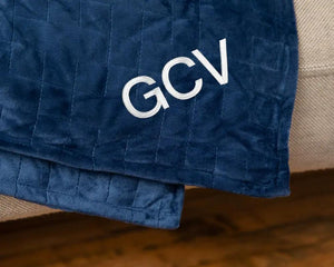 Original Weighted Blanket in navy blue quilted fabric featuring the GCV logo