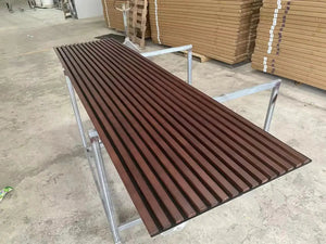 Hausvita acoustic solid wood slat wall panel in brown on a metal-framed bench