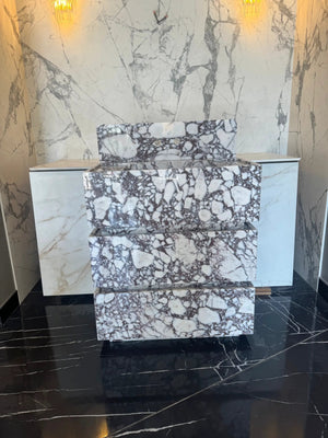 Calacatta Viola marble freestanding vanity with stacked block design in white with purple-gray veining