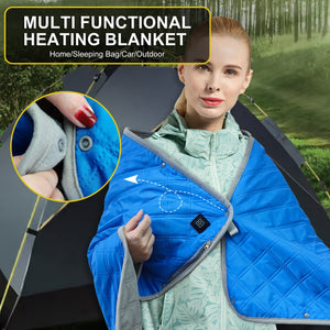 LITEGUEST Heated Camping Blanket, blue quilted outdoor blanket with USB heating worn by a woman beside a tent.