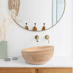 Light beige travertine sloped vanity bathroom vessel sink with brass faucet, honed finish
