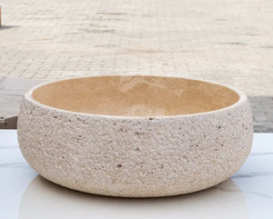 Light beige travertine vessel sink for above-counter vanity; round bowl with rough exterior and smooth interior, 16in dia x 6in high