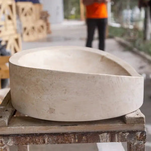 Stone sink in light travertine, bathroom vanity vessel with round honed finish.