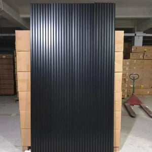 Luxury black acoustic solid wood wall panel with vertical grooves.