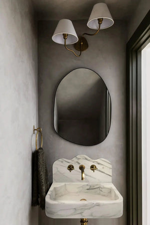 Calacatta white marble wall-mount bathroom sink with brass faucet and arabesque backsplash