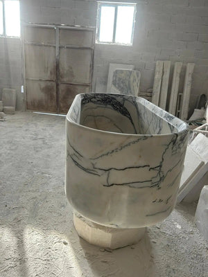 New York marble bathtub handcrafted from solid marble block; white with dark veining