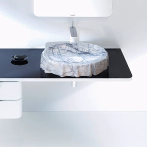 Marble vessel sink on black countertop with chrome faucet; polished New York Marble Designer by Villohome; Duravit logo.