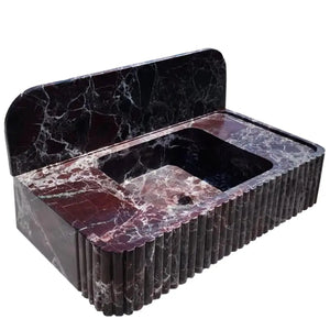 Rosso Levanto marble wall-mount bathroom sink with fluted front and 8-inch backsplash