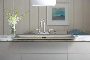 Seagrass Fossil Limestone rectangular bathroom vanity sink with chrome faucet on white countertop.
