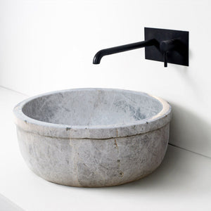 Sirius Silver Marble natural stone bathroom sink, gray round bowl with a black wall-mounted faucet.