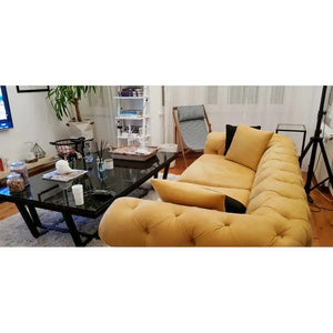Marble coffee table with rectangular top and polished black metal legs.