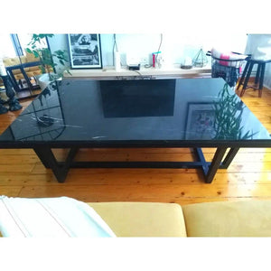 Marble coffee table with rectangular top and polished black metal legs