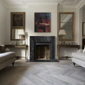 Toros black marble hand-carved fireplace mantel, polished with white veining, in a classic living room.