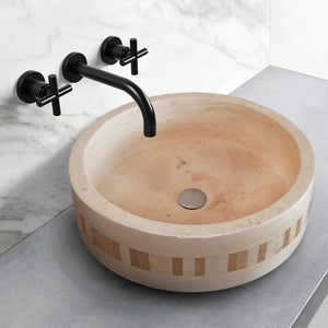 Troia Light Travertine cylinder vanity sink with a 2-inch embedded mosaic border and matte black wall faucet