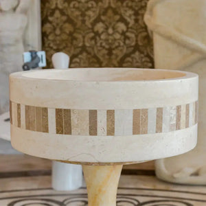 Troia Light Travertine cylinder vanity sink with a 2-inch embedded mosaic border by Villohome.