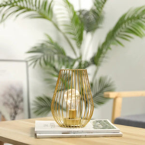 8-inch tall cage-shaped table lamp with a gold wire frame, battery-operated