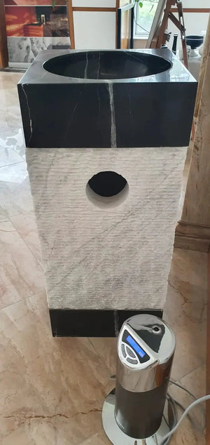 Natural stone marble pedestal sink with black top and white textured base