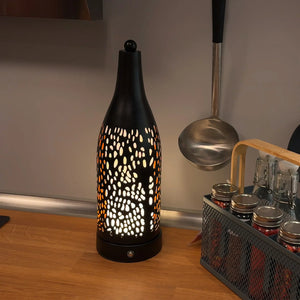 Cordless table lamp with black perforated metal shade and warm glow